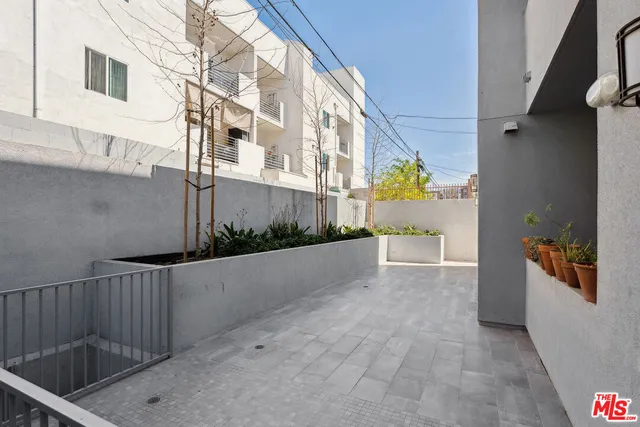 a terrace with outdoor seating and barbeque oven