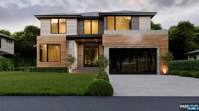 a front view of a house with a garden and yard