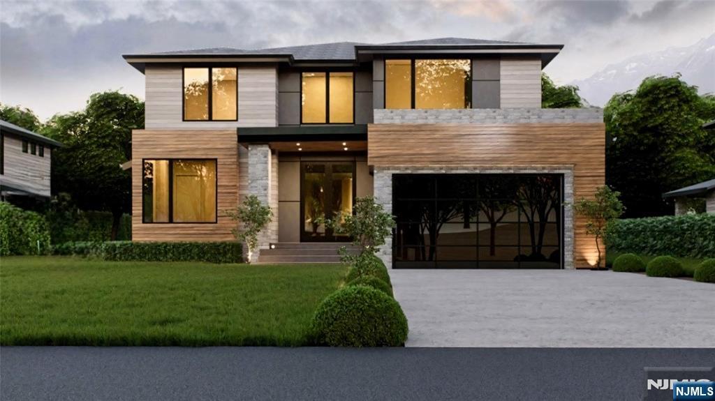 a front view of a house with a garden and yard