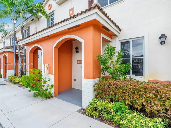 front view of a house with potted plants