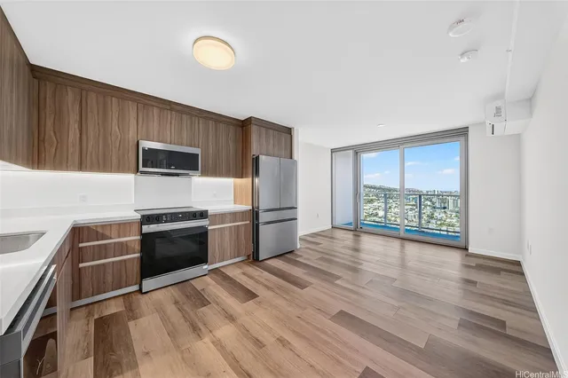a kitchen with granite countertop a stove a sink and a refrigerator