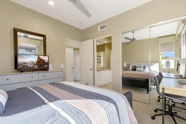 a bedroom with a bed and a flat screen tv