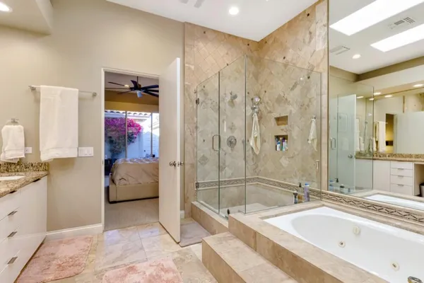 a bathroom with a tub a sink and a shower