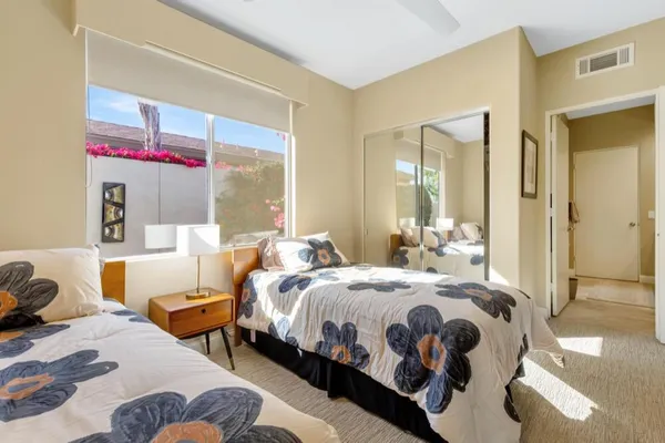 a bedroom with a bed and a mirror