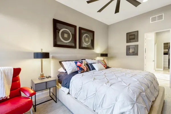 a bedroom with a bed and lamp