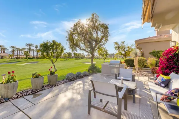 a view of a backyard with sitting area