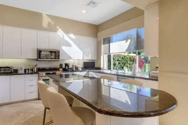 a kitchen with a stove a sink and a microwave