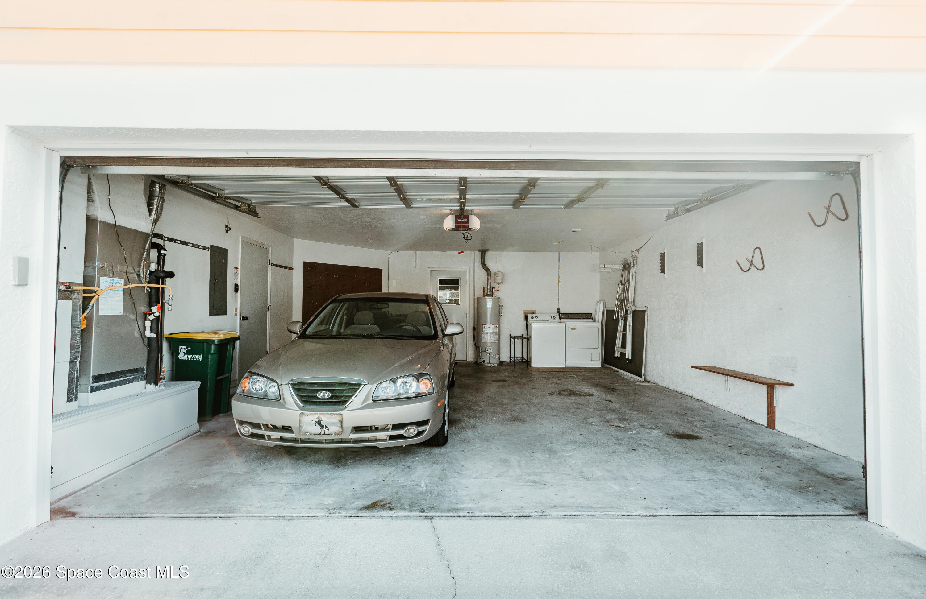 905 Maplewood Court Melbourne, FL 32940 - Photo 3 of 23 a living room with furniture and a chandelier