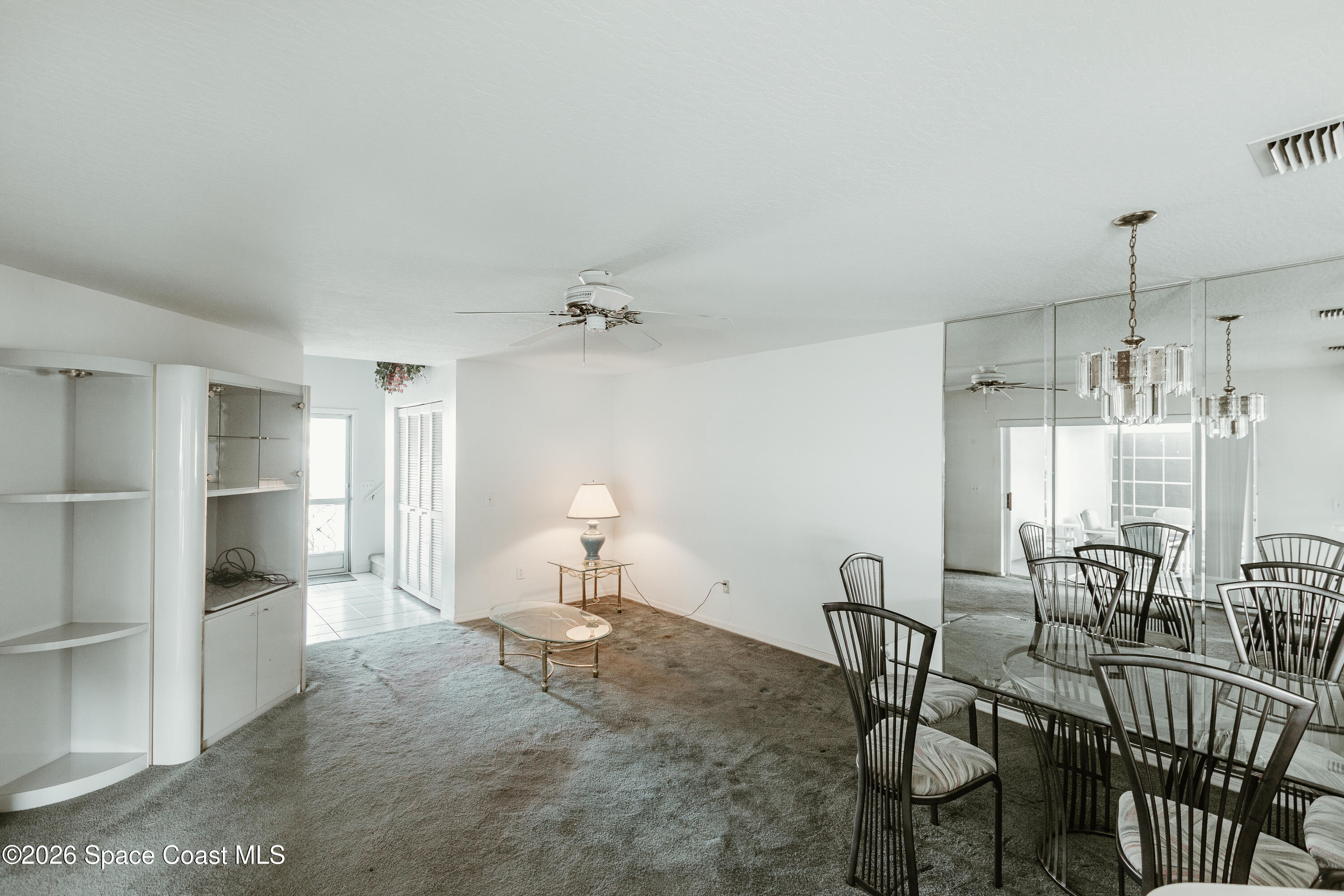 905 Maplewood Court Melbourne, FL 32940 - Photo 4 of 23 a living room with furniture a dining table and chairs