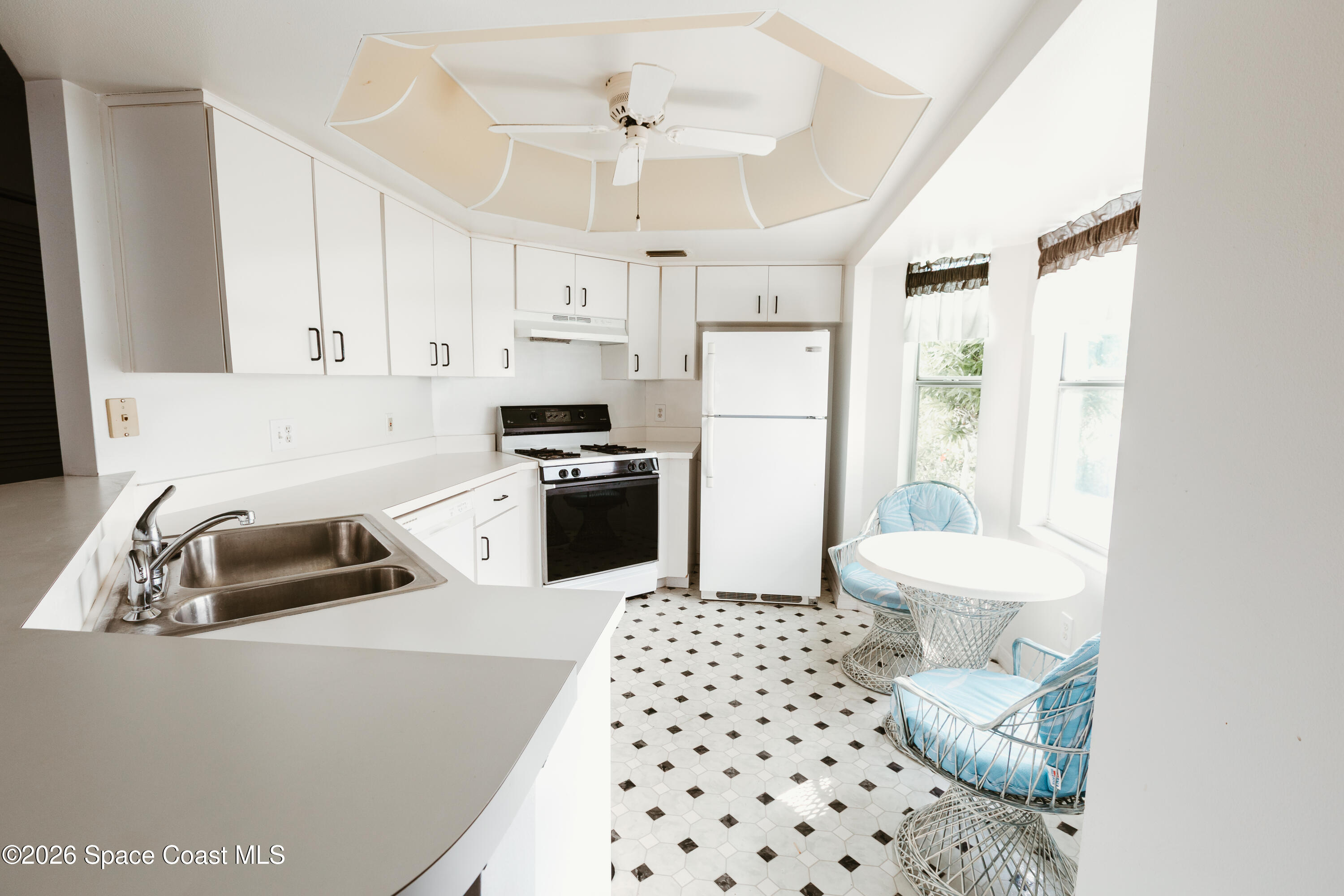 905 Maplewood Court Melbourne, FL 32940 - Photo 5 of 23 a kitchen with granite countertop a sink a counter space appliances and cabinets