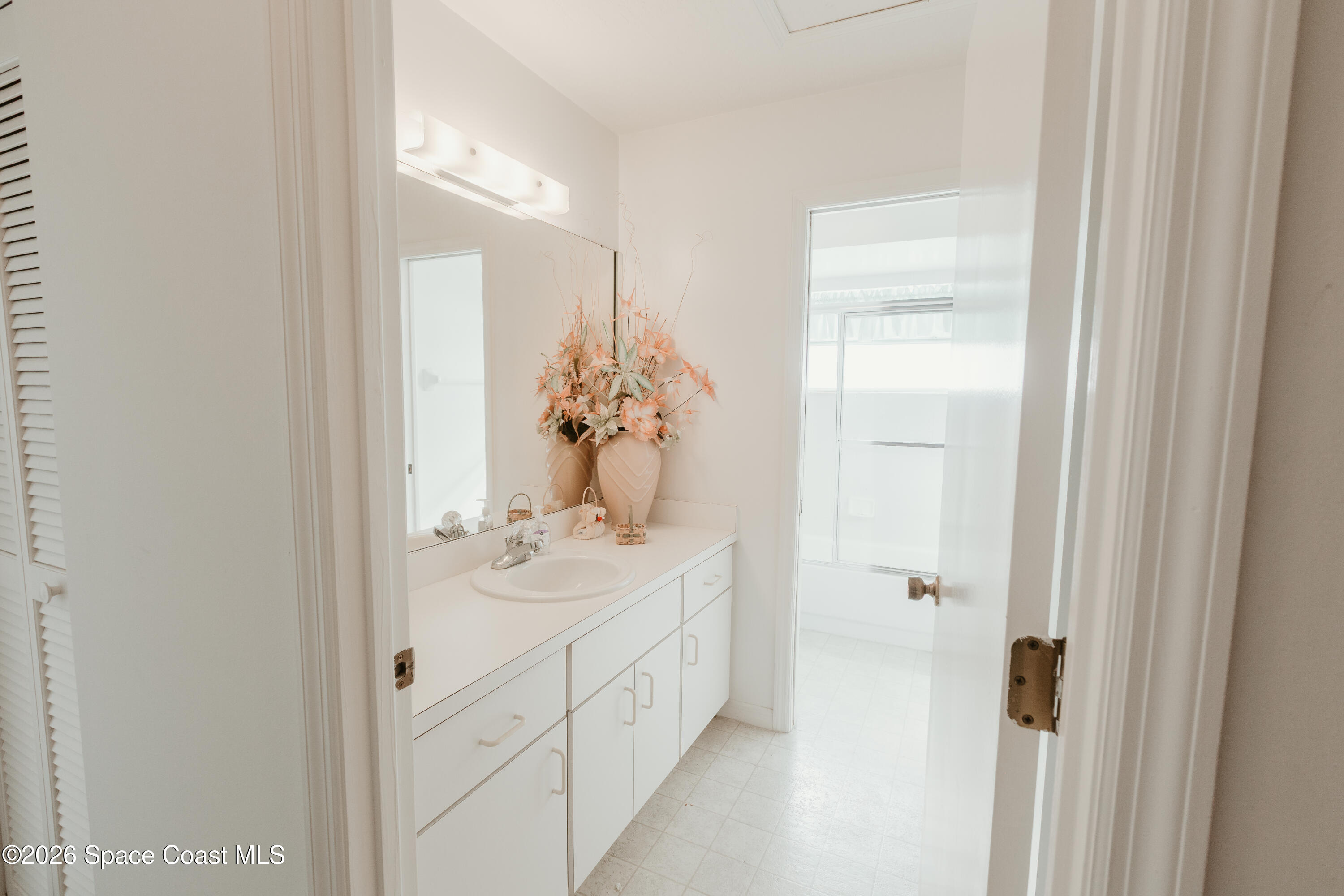 905 Maplewood Court Melbourne, FL 32940 - Photo 9 of 23 a bathroom with a sink and mirror