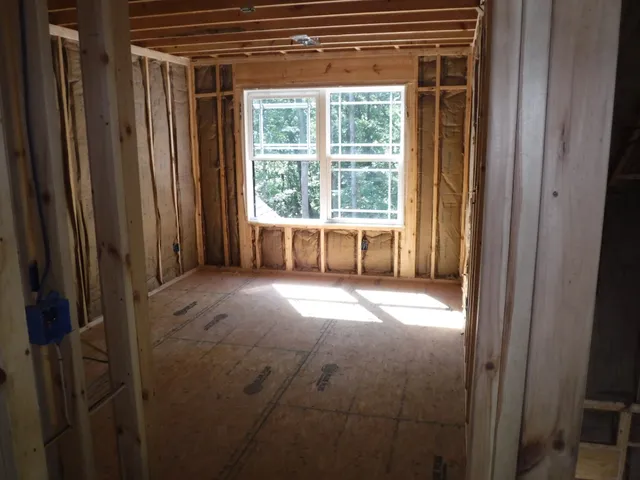 a view of empty room with floor to ceiling window