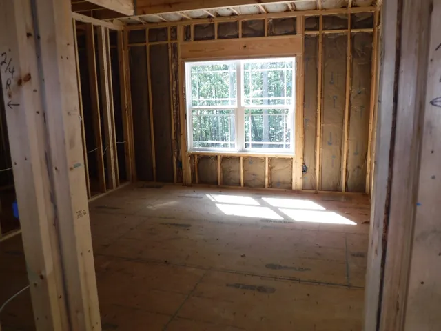a view of empty room with window and front door
