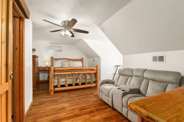 a bedroom with furniture and a ceiling fan