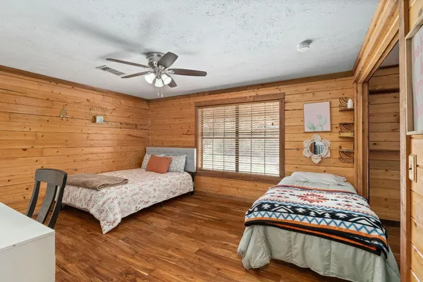 a bedroom with a bed and a chandelier
