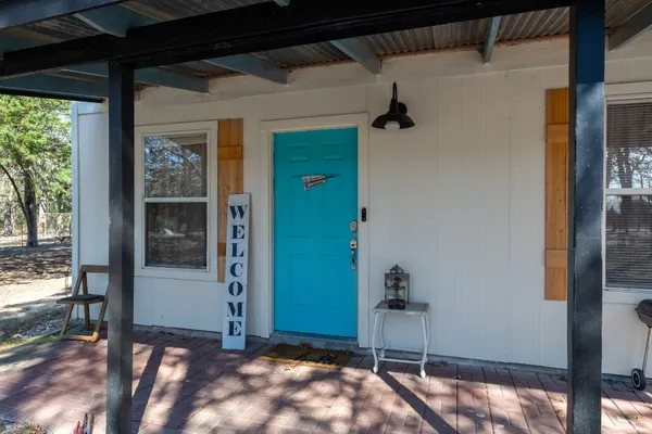 a view of a porch with a table and chairs