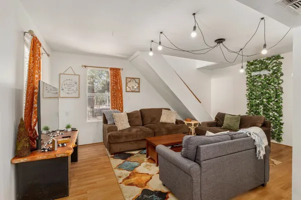 a living room with furniture and a chandelier