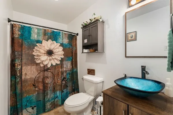 a bathroom with a toilet sink and shower