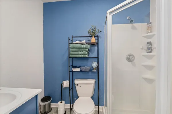 a white toilet sitting next to a bathroom sink