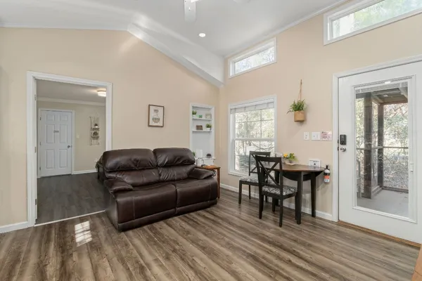 a living room with furniture and a wooden floor