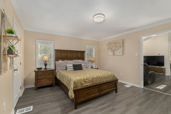 a bedroom with a bed and a flat screen tv