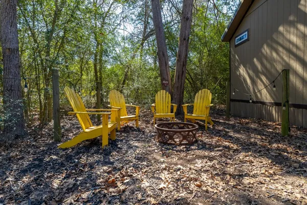 a view of a backyard with table and chairs