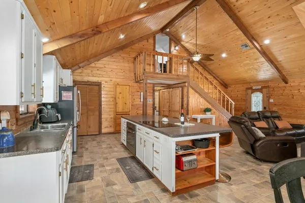 a view of a kitchen with a sink and cabinets