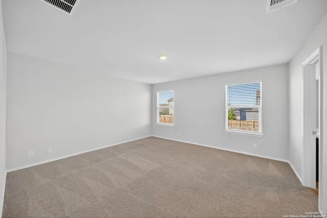 an empty room with windows and closet