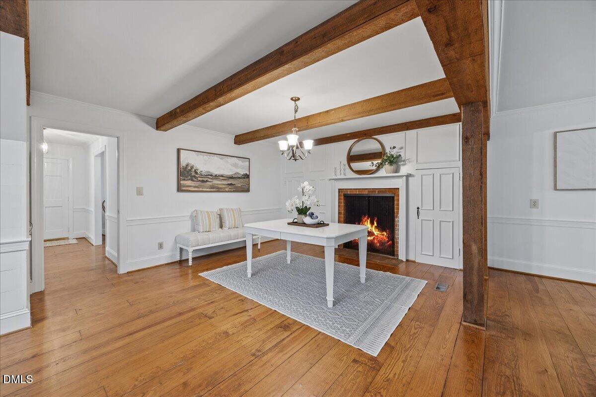 6516 Bakersfield Drive Raleigh, NC 27606 - Photo 17 of 59 a living room with furniture a fireplace and wooden floor