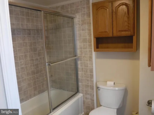 a bathroom with a shower a toilet and a sink
