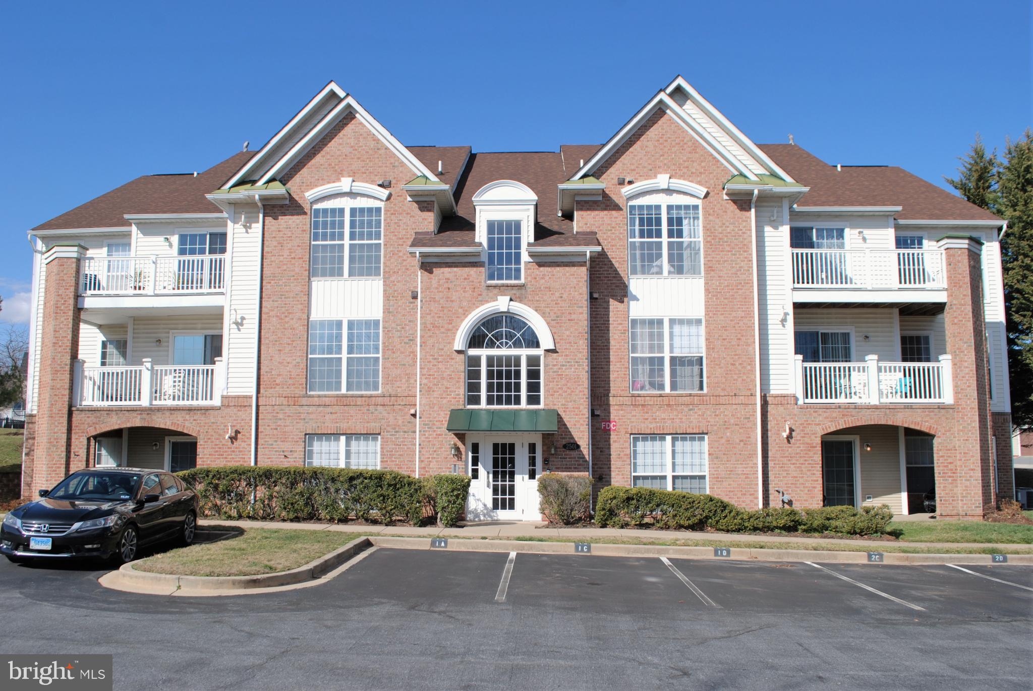 a front view of a residential apartment building with a yard