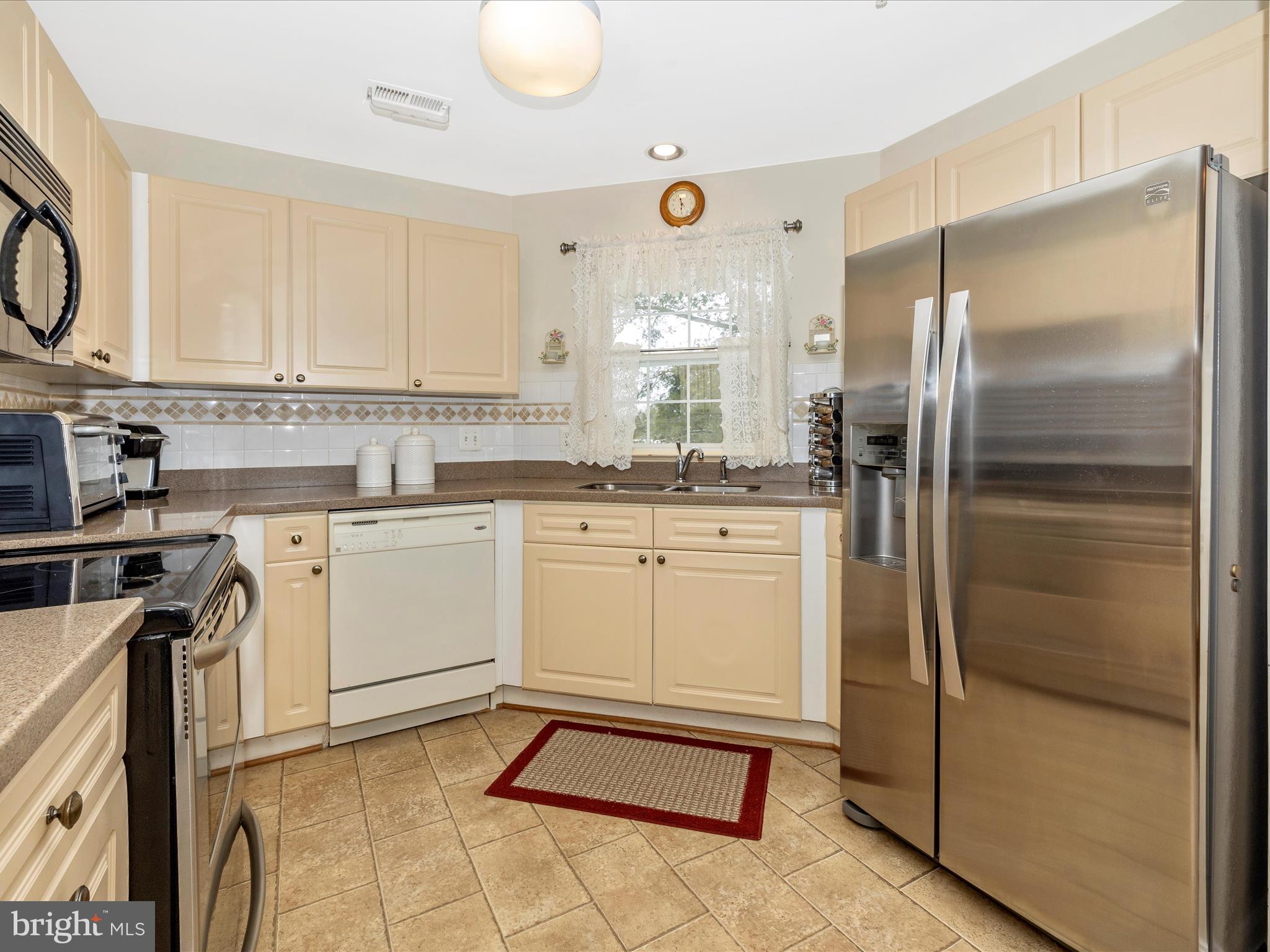 2501 Coach House Way, Unit 2C Frederick, MD 21702 - Photo 13 of 54 a kitchen with a refrigerator sink and cabinets