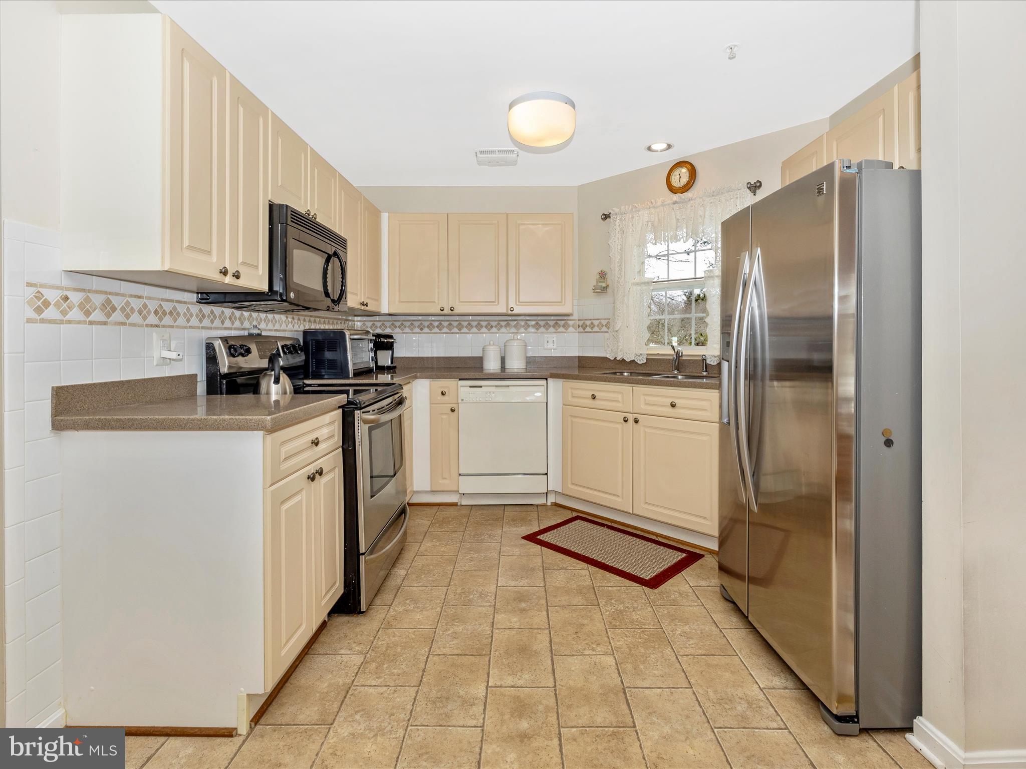 2501 Coach House Way, Unit 2C Frederick, MD 21702 - Photo 14 of 54 a kitchen with stainless steel appliances granite countertop a refrigerator and a stove top oven