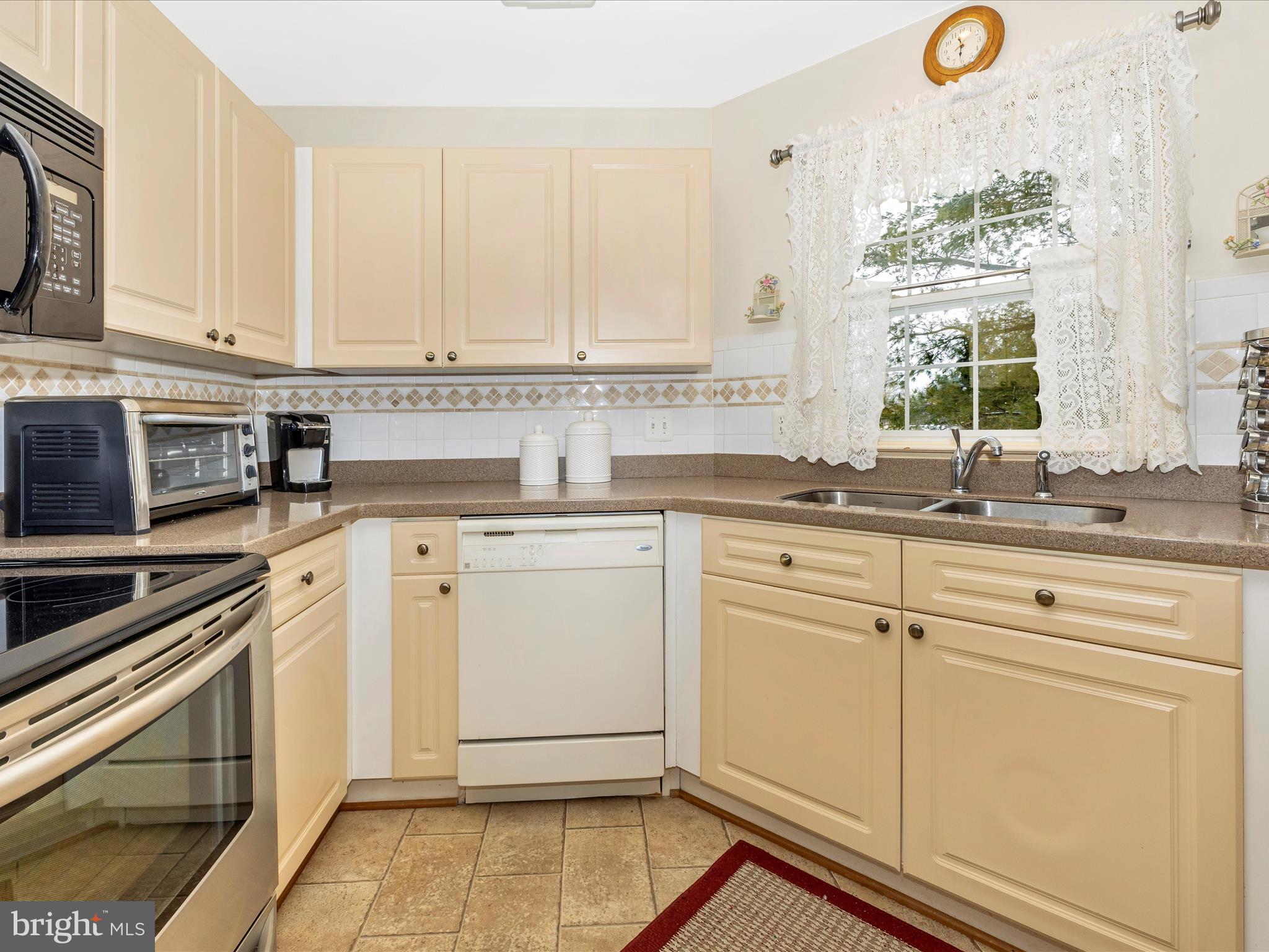 2501 Coach House Way, Unit 2C Frederick, MD 21702 - Photo 15 of 54 a kitchen with appliances cabinets and a sink