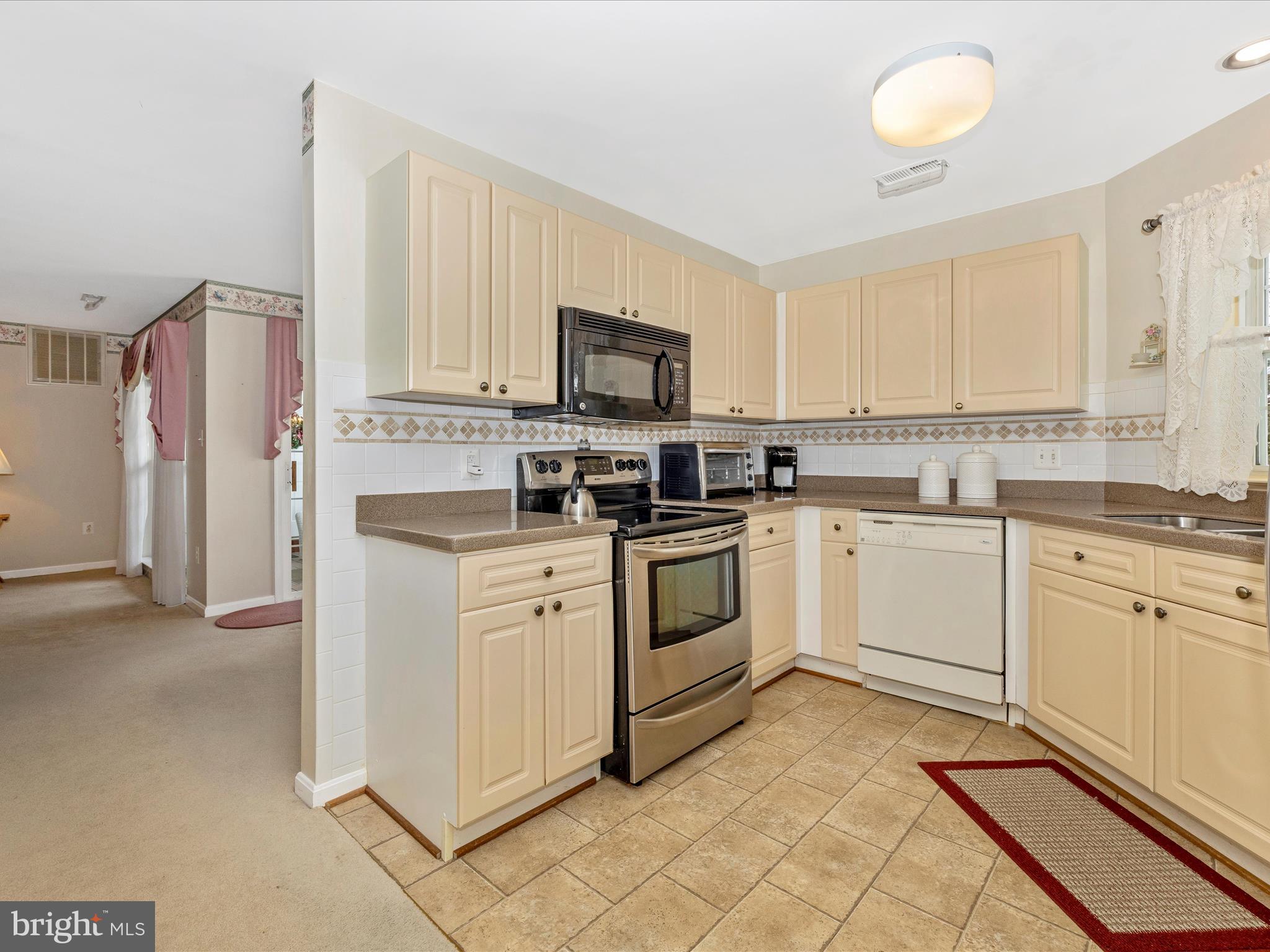 2501 Coach House Way, Unit 2C Frederick, MD 21702 - Photo 16 of 54 a kitchen with white cabinets and white appliances