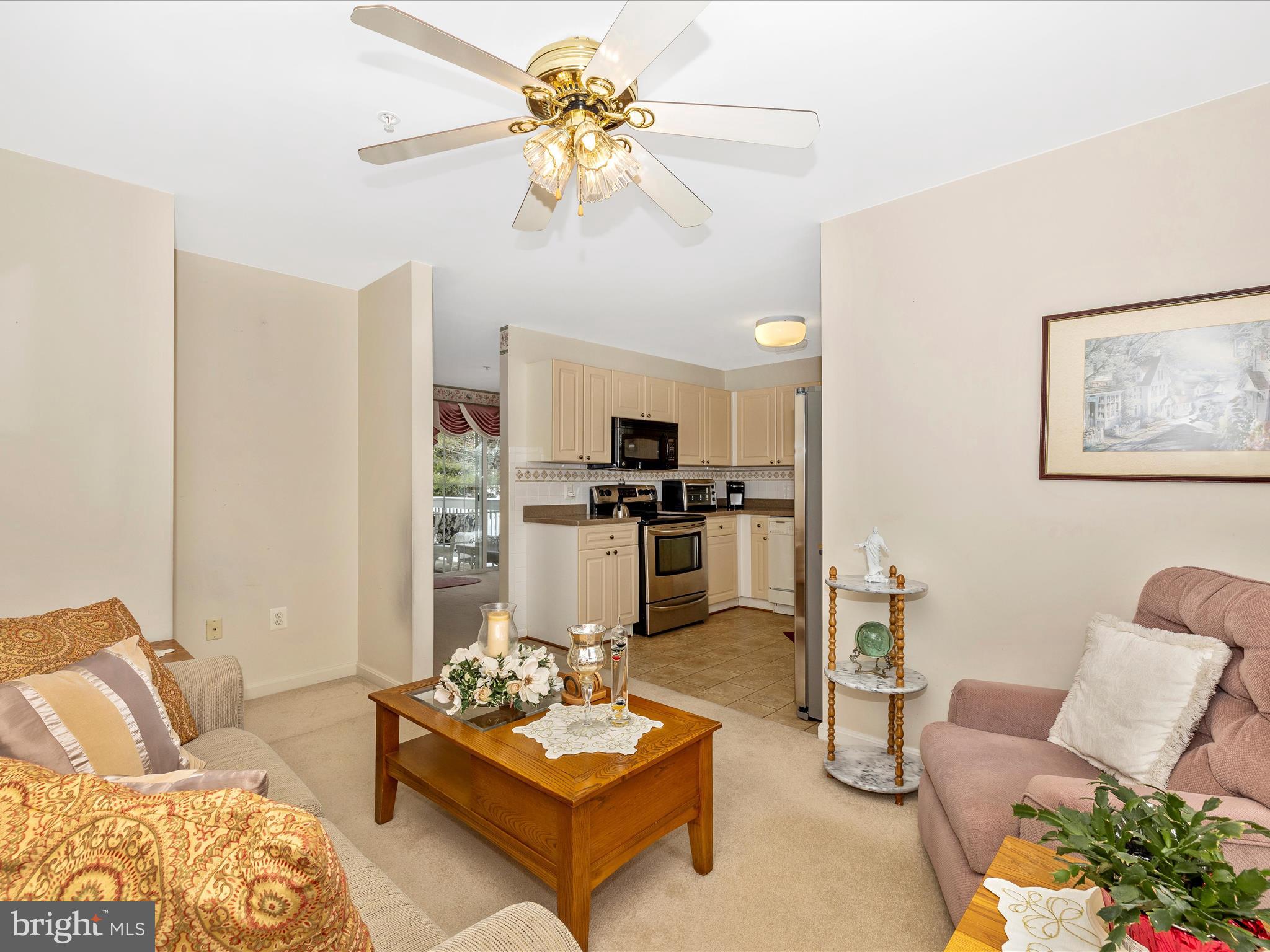 2501 Coach House Way, Unit 2C Frederick, MD 21702 - Photo 19 of 54 a living room with furniture a chandelier and a table