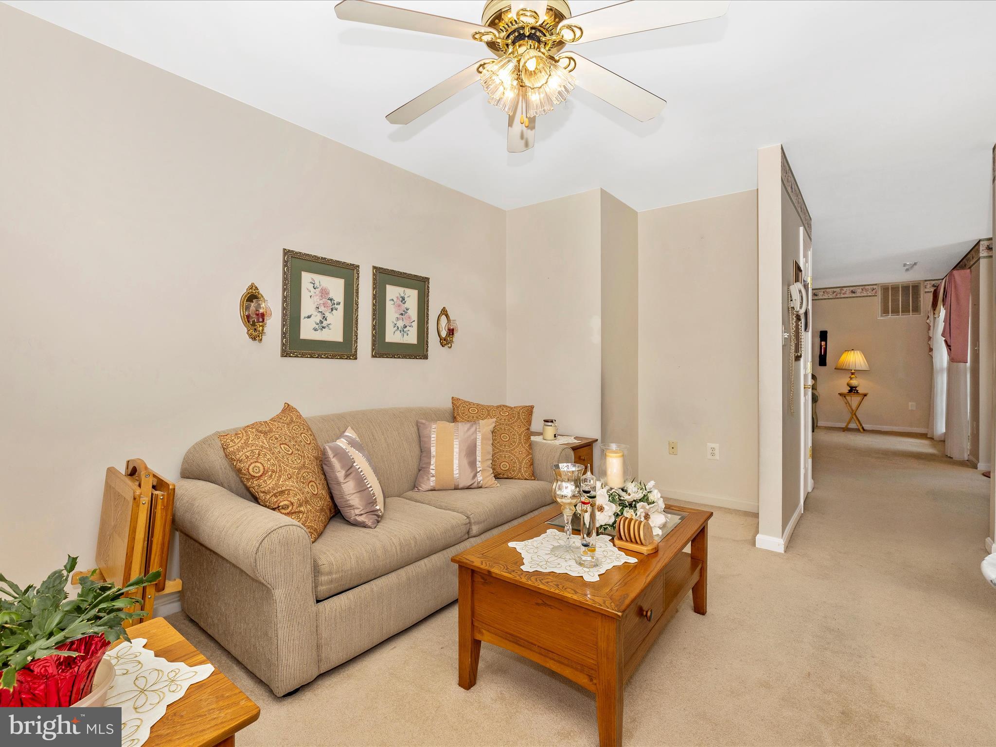 2501 Coach House Way, Unit 2C Frederick, MD 21702 - Photo 20 of 54 a living room with furniture and a chandelier