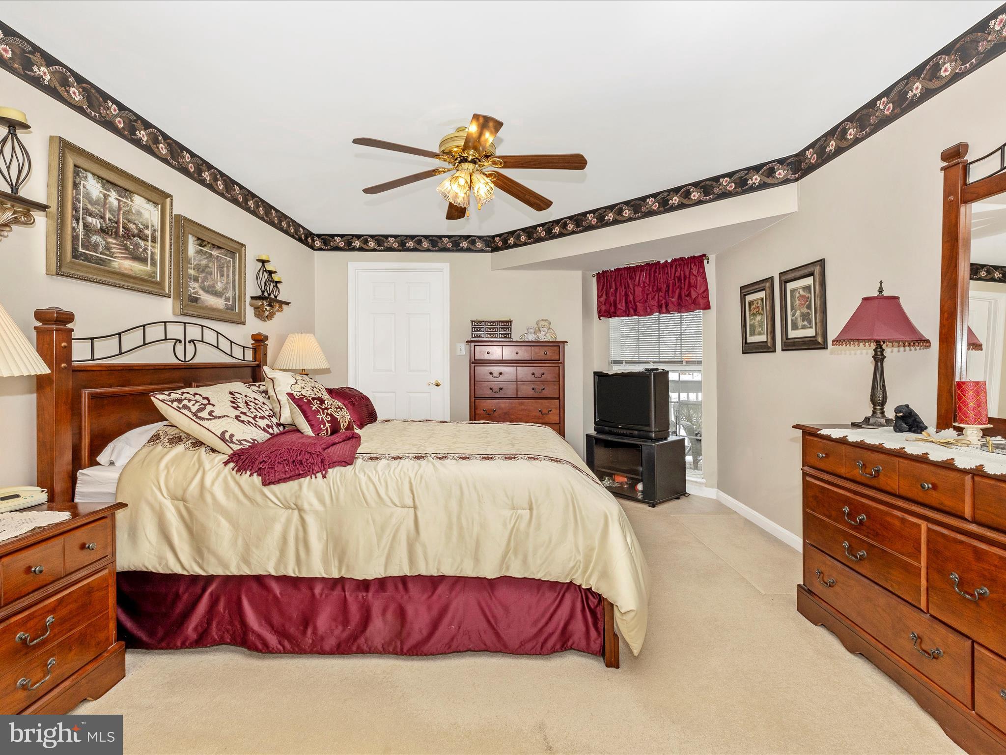 2501 Coach House Way, Unit 2C Frederick, MD 21702 - Photo 26 of 54 a bedroom with a bed and a chandelier