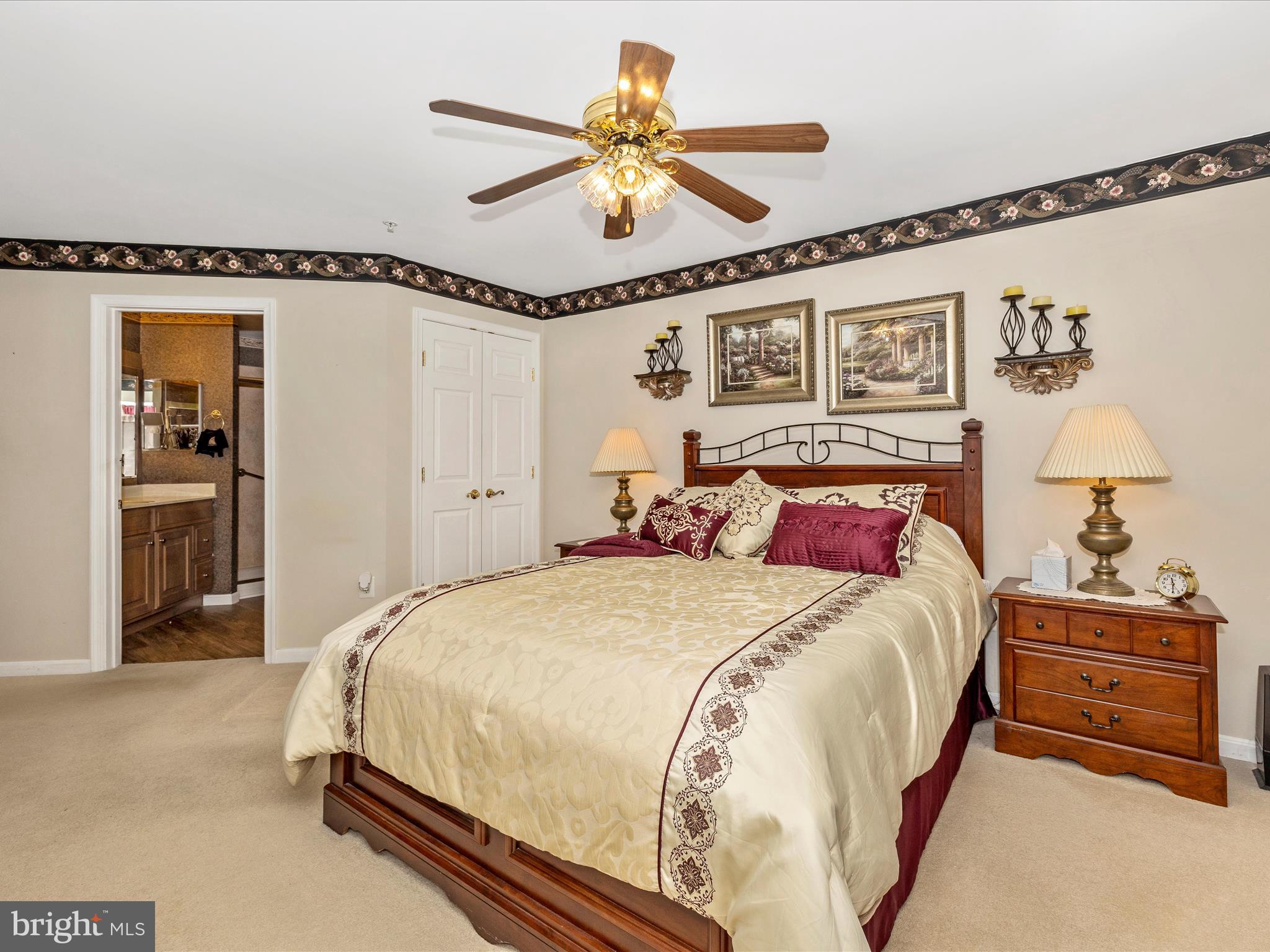 2501 Coach House Way, Unit 2C Frederick, MD 21702 - Photo 28 of 54 a bedroom with a bed and a chandelier