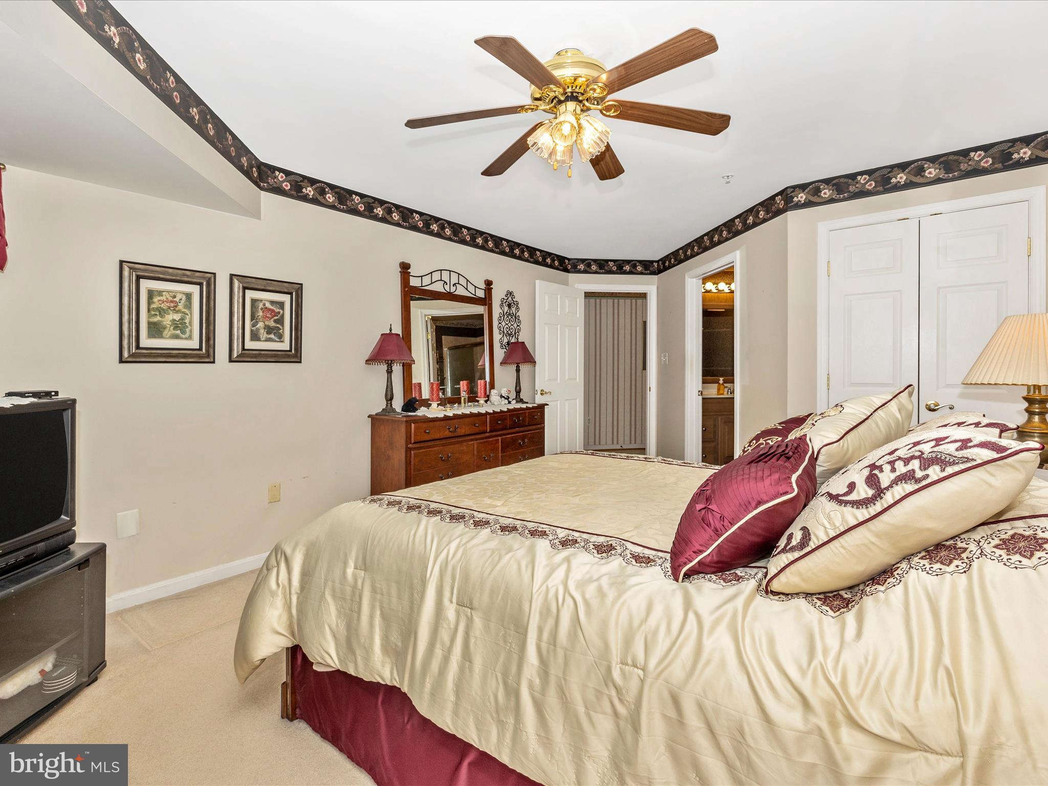 2501 Coach House Way, Unit 2C Frederick, MD 21702 - Photo 29 of 54 a bedroom with a bed ceiling fan and a flat tv screen