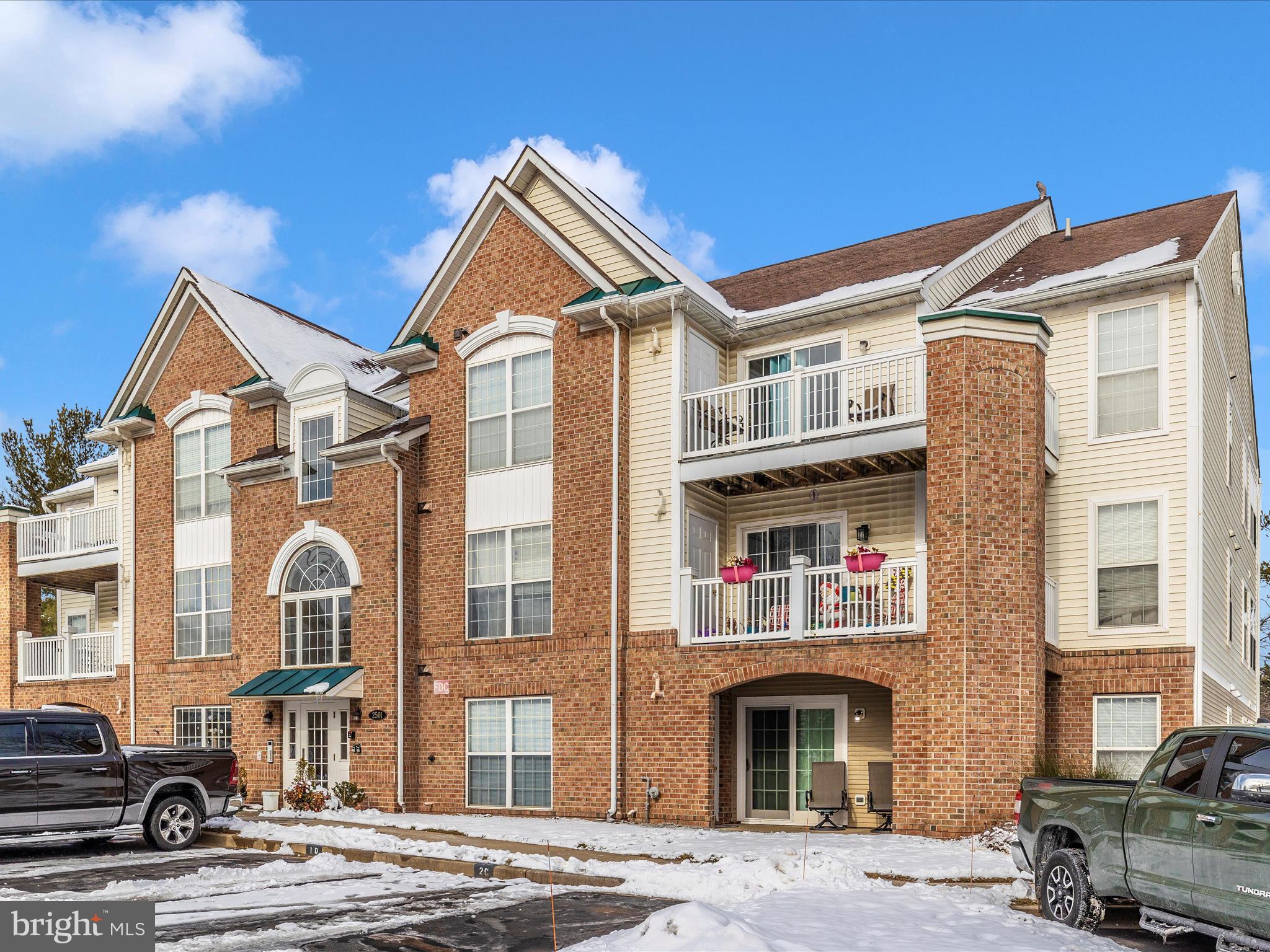 2501 Coach House Way, Unit 2C Frederick, MD 21702 - Photo 39 of 54 a front view of a residential apartment building with a yard