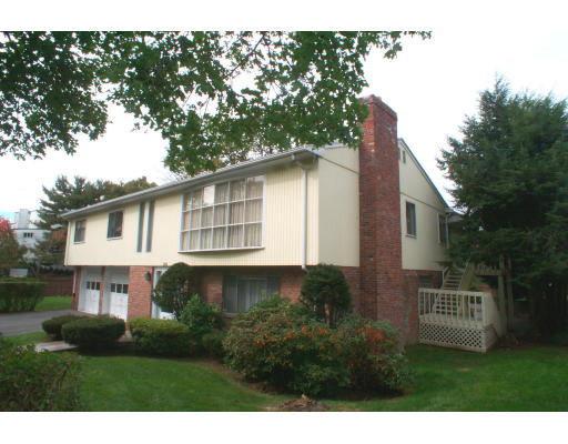 163 Bellingham Road Brookline, MA 02467 - Photo 1 of 1 a front view of a house with a yard and garage