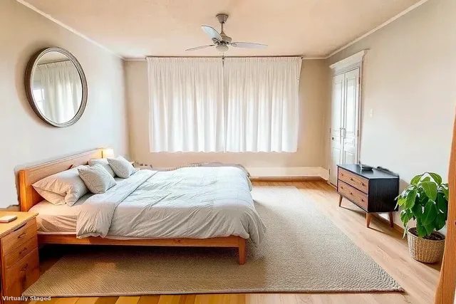 a bedroom with a bed and a potted plant