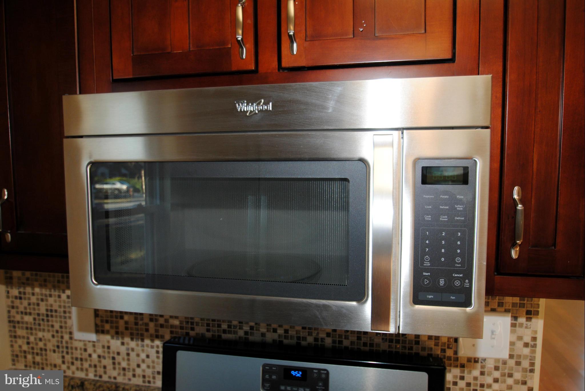 716 Milford Mill Road Baltimore, MD 21208 - Photo 12 of 19 a refrigerator with a microwave