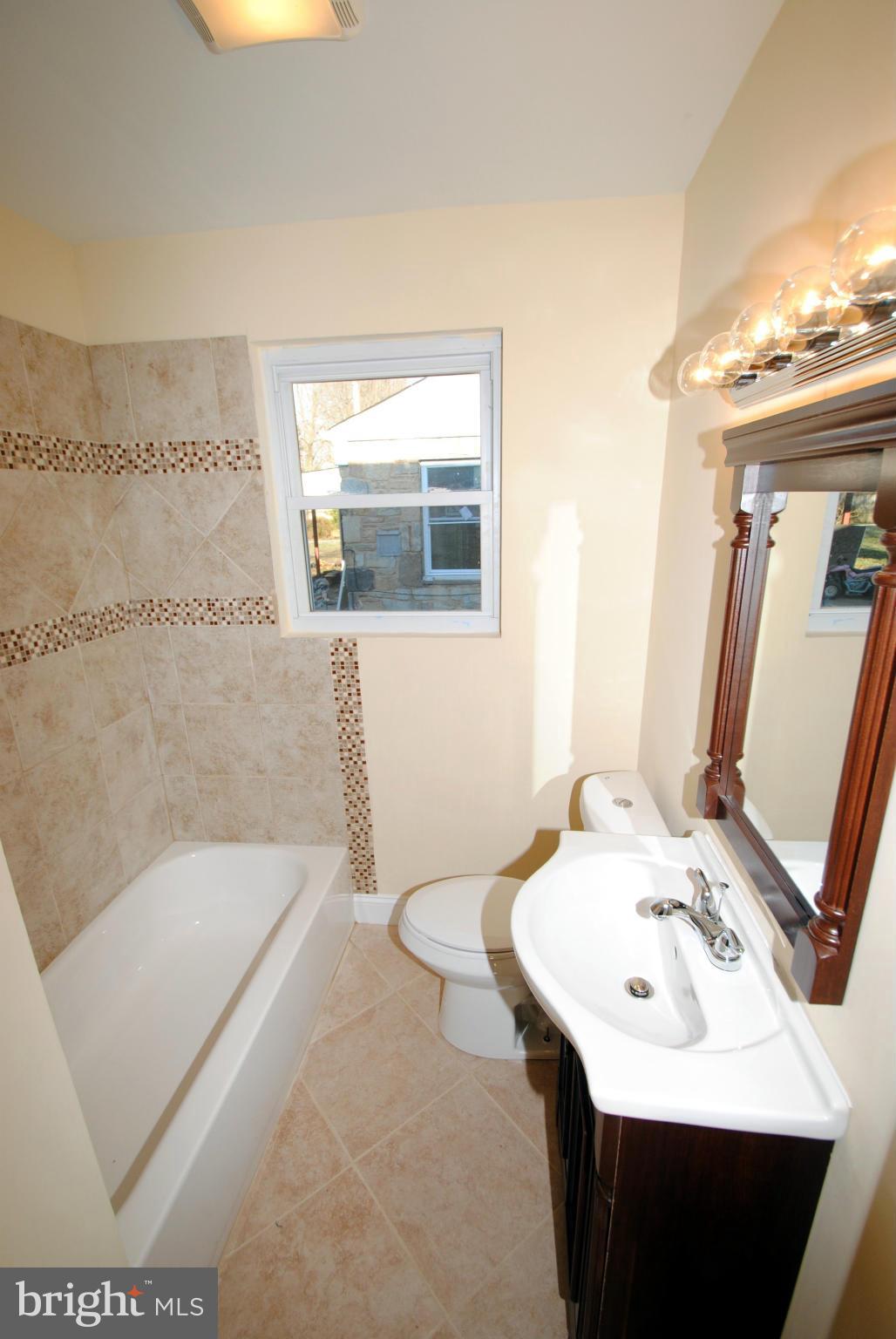 716 Milford Mill Road Baltimore, MD 21208 - Photo 13 of 19 a bathroom with a sink and a mirror
