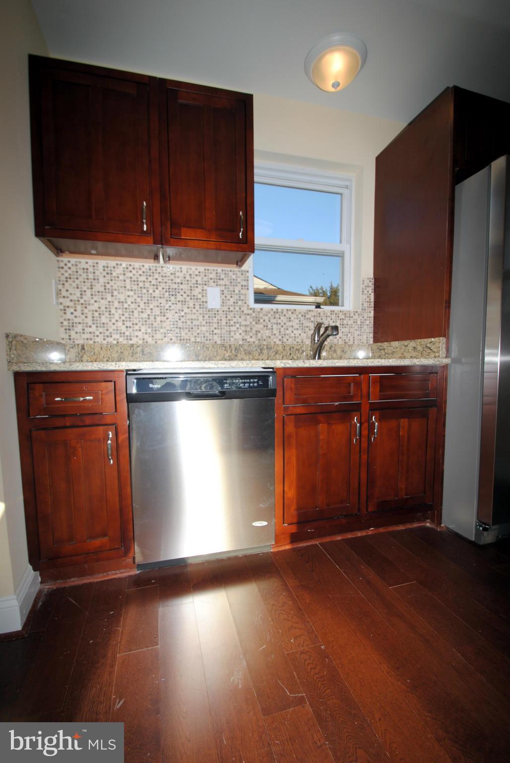 716 Milford Mill Road Baltimore, MD 21208 - Photo 7 of 19 a kitchen with granite countertop wood cabinets stainless steel appliances and a sink