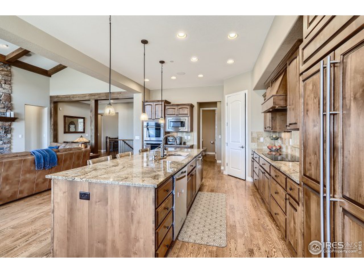 9670 Phillips Road Lafayette, CO 80026 - Photo 11 of 33 a large kitchen with kitchen island a large counter top space a sink stainless steel appliances and cabinets