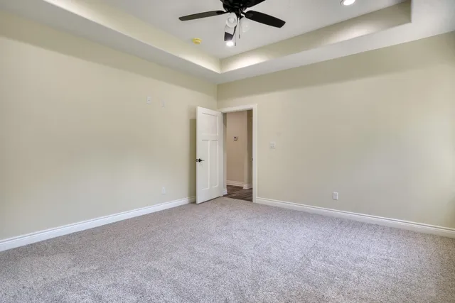 an empty room with a chandelier fan