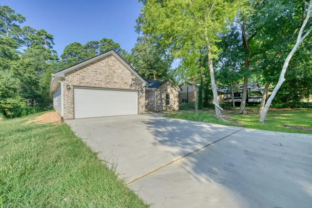 a view of a house with a yard and garage