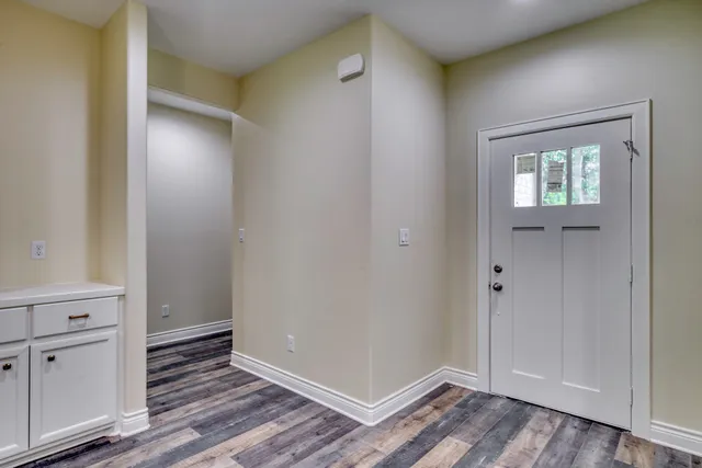 a view of an empty room and wooden floor